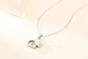 Detailed view of an elephant pendant with a sparkling gemstone eye on silver chain