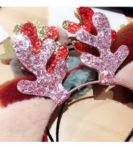 Detailed close-up of sequined Christmas reindeer antlers with plush ear decorations