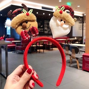 Detail of Christmas headband with plush Santa Claus and reindeer on a red fabric band