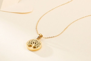 Detailed shot of golden tree of life pendant on a fine O-chain necklace for women