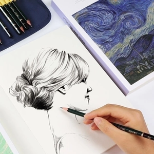 Close-up of hand sketching on premium sketchpad with a professional 2B drawing pencil