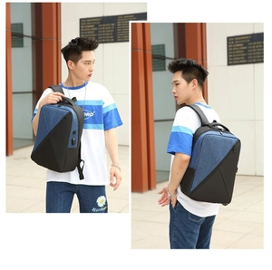 Detail of laptop backpack with USB charging port and blue geometric patchwork pattern