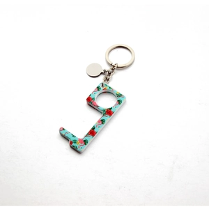 Detail of acrylic no-touch door opener keychain with tropical flamingo and floral pattern