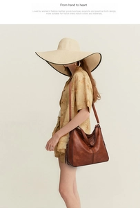 Brown leather tote bag worn by a model in a stylish outfit, showing size and carry style