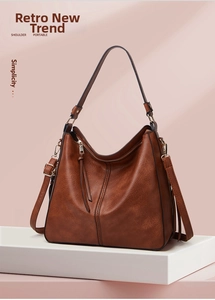 Close-up of retro brown faux leather tote bag with stylish fringe zipper and wide strap