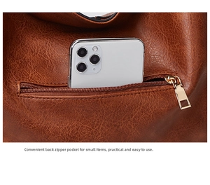 Detailed close-up of brown vintage tote bag with functional back zipper pocket for phone