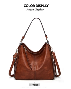 Front view of brown vintage tote bag with golden hardware and fringe tassel detail