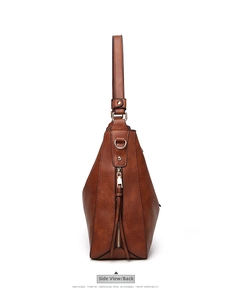 Side view of brown vintage tote bag featuring side zipper and long tassel detail