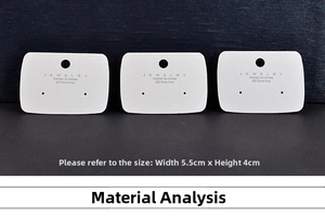 Detailed view of three white jewelry display cards with mounting holes for earrings