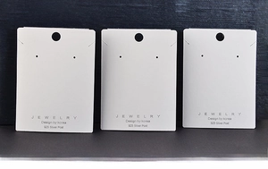 Detail of white 6x8cm jewelry display cards for necklace and earring set presentation