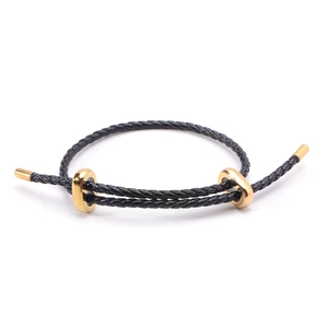 Bracelet ajustable en corde tressée noire avec détails minimalistes en finition dorée