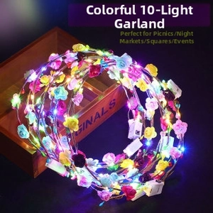 Close-up of colorful floral LED wreath featuring 10 glowing lights and battery control box