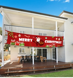 Outdoor Merry Christmas banner in vibrant red hung on a house balcony for festive decoration