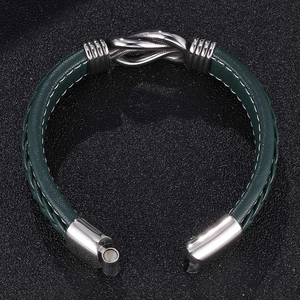 Green leather punk bracelet with silver metal knot and magnetic clasp on black background