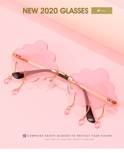 Detailed macro of pink cloud-shaped sunglasses with golden metal chain and teardrop charms