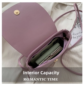 Detail of the lilac crossbody bag showing spacious interior compartment and phone storage