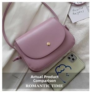 Top view of purple PU leather flap crossbody bag with golden magnetic clasp on fabric