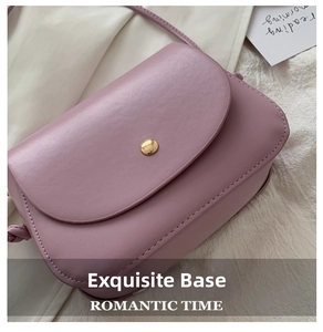 Detail view of the lavender leather crossbody bag with elegant golden round buckle and flap
