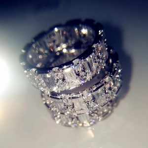 Elegant silver sparkling square-cut crystal eternity rings stacked in a luxury setting
