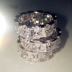 Sparkling silver eternity rings with emerald and round cut crystals in a stacked style