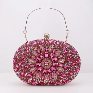 Macro shot of pink rhinestone evening clutch with crystal floral patterns and golden chain