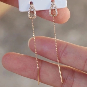 Rose gold water drop tassel threader earrings with white crystals held in hand