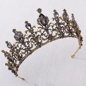 Detailed close-up of Baroque crown with grey gems and rhinestones on linen background