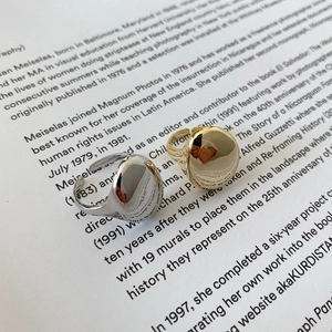 Macro shot of minimalist gold and silver adjustable rings on a vintage text background