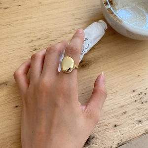 French style 925 sterling silver gold ring worn by model on a wooden background