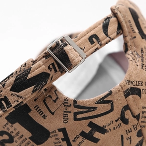 Detail of suede baseball cap with silver metal buckle and graffiti print fabric