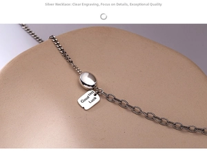 Detailed close-up of retro silver necklace with engraved Good S925 Luck square pendant