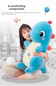 Detail of giant blue plush dinosaur toy with colorful lollipop embroidery and red back scales
