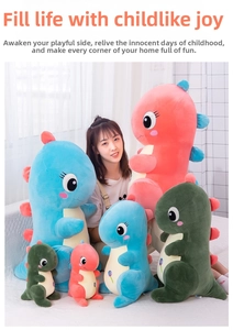 Close-up of soft dinosaur plush toys in blue, pink and green on a white sofa