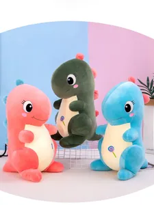 Detail of plush dinosaur toys in pink green and blue with embroidery and back fins