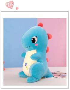 Detail of blue plush dinosaur toy featuring soft pink dorsal fins and embroidered lollipop