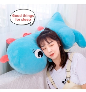 Detail showing the soft light blue dinosaur plush pillow with soft down cotton filling