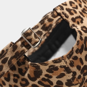 Detail of leopard print baseball cap featuring an adjustable silver metal buckle closure