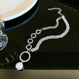 Elegant silver-toned necklace with rhinestones circular links and a large pearl drop