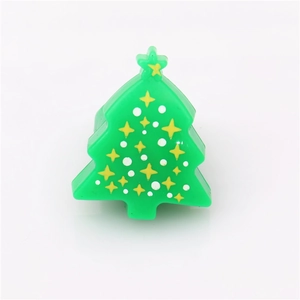Close-up of green glowing Christmas tree rubber ring with a yellow star on top