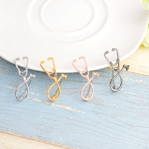 Creative alloy stethoscope brooches in silver, gold, rose gold, and gun black finishes