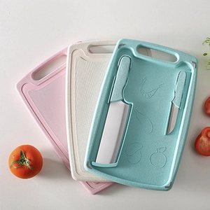 Three-piece wheat straw cutting board set with knives in pink, beige, and blue finishes