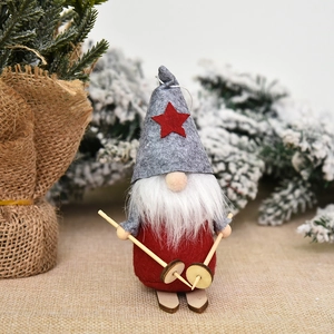 Christmas gnome skier ornament with red hat and wooden skis on a rustic pine background