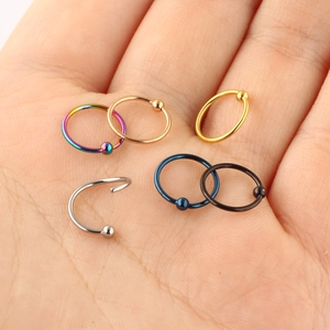 Surgical steel nose hoops and tragus rings set in silver, gold, and rainbow colors
