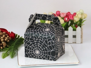 Detail of black Halloween cake box with white spider web pattern and handle