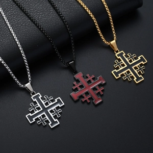 Three Jerusalem cross necklaces in silver, gold, and black finish on leather background