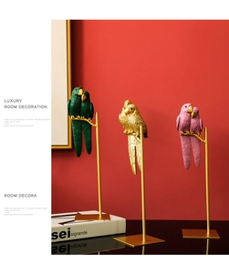 Artistic close-up of colorful resin parrots on a gold stand for home decor