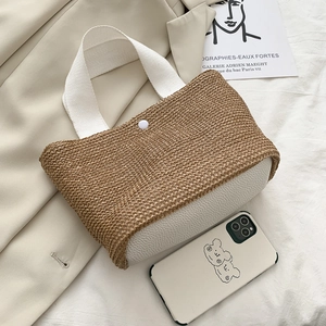 Summer woven straw handbag with white faux leather base and canvas handles for beach trips