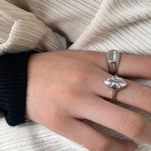 Silver signet ring and marquise-cut zircon ring set worn on model's hand
