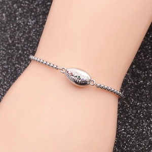 Detailed close-up of a silver stainless steel shell bracelet with colorful gemstones