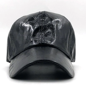 Front view of a shiny black faux leather baseball cap with a high-gloss finish